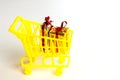 Online shopping concept - trolley cart full of presents.