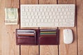 Online shopping concept with wallet, money and keyboard on wooden background Royalty Free Stock Photo