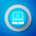 Online shopping concept. White Shopping cart on screen laptop icon isolated on blue background. Concept e-commerce Royalty Free Stock Photo