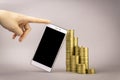 Online shopping concept. white smartphone, and coins on a gray background Royalty Free Stock Photo