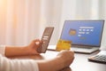 Online shopping concept, Woman holding credit card with mobile phone and using laptop computer. internet banking, spending money Royalty Free Stock Photo