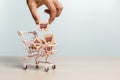 Online shopping delivery market concept. hand holding wooden cubes block with shopping cart icons in shopping trolley, sell Royalty Free Stock Photo