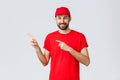 Online shopping, delivery during quarantine and takeaway concept. Friendly handsome bearded employee, courier in red
