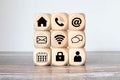 Online shopping or e-commerce concept with online business icons on wooden cubes against white background Royalty Free Stock Photo