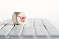 Online shopping and e-commerce concept with shopping cart icon on wooden cube on computer keyboard. Royalty Free Stock Photo