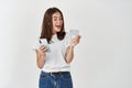 Online shopping and ecommerce. Happy young woman using mobile phone and holding plastic credit card, making purchase Royalty Free Stock Photo