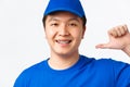 Online shopping, fast shipping, employees and home delivery concept. Close-up of confident smiling asian male courier in Royalty Free Stock Photo