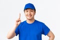 Online shopping, fast shipping, employees and home delivery concept. Confident smiling asian male courier with braces Royalty Free Stock Photo