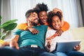 Happy african family having fun using credit card and digital tablet at home Royalty Free Stock Photo