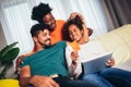 Happy african family having fun using credit card and digital tablet at home Royalty Free Stock Photo