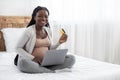 Online Shopping. Happy Pregnant Woman With Laptop And Credit Card On Bed Royalty Free Stock Photo