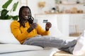 Online Shopping. Happy Young Black Man Using Smartphone And Credit Card Royalty Free Stock Photo