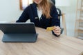 Online Shopping and Internet Payments, Beautiful Asian women are using their credit cards and tablet computer laptop to Royalty Free Stock Photo