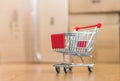 Concept of online shopping: Little shopping cart on delivery boxes Royalty Free Stock Photo