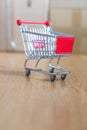 Concept of online shopping: Little shopping cart on delivery boxes Royalty Free Stock Photo