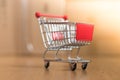 Concept of online shopping: Little shopping cart on delivery boxes Royalty Free Stock Photo