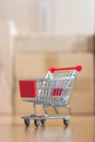 Concept of online shopping: Little shopping cart on delivery boxes Royalty Free Stock Photo