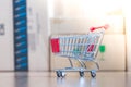 Concept of online shopping: Little shopping cart on delivery boxes Royalty Free Stock Photo