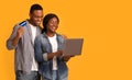 Online Shopping. Portrait of cheerful black lovers with laptop and credit card Royalty Free Stock Photo