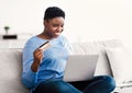 Black curvy woman using computer and credit card at home Royalty Free Stock Photo