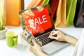 Online shopping, Shopaholic woman holding money cash, Sale promotion sign on laptop computer. Royalty Free Stock Photo