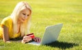 Online Shopping. Smiling Blonde Girl with Laptop Royalty Free Stock Photo