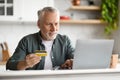 Online Shopping. Smiling Senior Man Using Laptop And Credit Card At Home Royalty Free Stock Photo