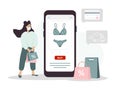 Online shopping on website or mobile app. Woman buys modern underwear at online lingerie store. The product catalog on