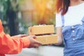 Online shopping, Woman receiving parcel from delivery man bringing some package at the home, shipping and postal service concept