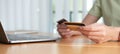 Online shopping. Young woman holding credit card and using laptop at home. African american girl working on computer at Royalty Free Stock Photo