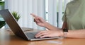 Online shopping. Young woman holding credit card and using laptop at home. African american girl working on computer at Royalty Free Stock Photo