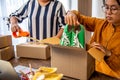 Online small business owner is packing products for customers according to their orders online-Shopping online concept