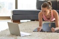 Online sport fitness yoga training. young woman and doing exercises on yoga mat opposite laptop