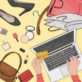 Online store concept with a laptop, cosmetics and shoes. Women`s hands with a credit card and laptop pay for purchases