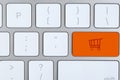 Online store. Orange button with shopping cart on computer keyboard, top view Royalty Free Stock Photo