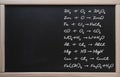 . Online training, chemistry. Tablet on the background of a class board with written chemistry formulas