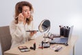 Online training for make-up. A woman teacher explains the makeup application scheme on the air Royalty Free Stock Photo