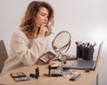 Online training for make-up. A woman teacher explains the makeup application scheme on the air Royalty Free Stock Photo