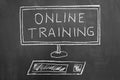 Online training text and computer drawing on chalkboard Royalty Free Stock Photo