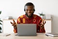 Online Tutoring. Male African Teacher In Headset Having Web Lesson With Laptop