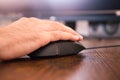 Online video game player`s hand detail. The hand is over the mouse, you can also see the illuminated keyboard on the gaming table Royalty Free Stock Photo