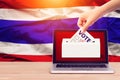 Online vote , poll, exit poll for Thailand general election concept. close up hand of a person casting a ballot at elections