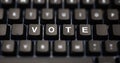 Online voting concept. Vote text written on keypad. Black keys with white letters message for election on pc keyboard. Blur