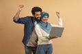 Online Win. Joyful Arabic Couple Holding Laptop And Celebrating Success Royalty Free Stock Photo