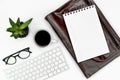 Online work and education layout. keyboard, glasses, coffee cup, note pad and laptop case. copy space flatlay Royalty Free Stock Photo