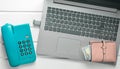 Online work, freelancing concept. Office phone, laptop, flash drive, wallet on a white wooden table.Top view Royalty Free Stock Photo