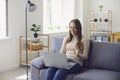 Online work at home. A woman works at a table in using a laptop she speaks with a partner through the video call chat