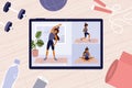 Online workout classes on digital tablet with young woman on screen doing exercises