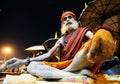 An onlooker Aghori Sadhu sits at the ghat