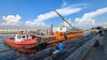 A tug boat positions a barge in the Tel Aviv Harbor Royalty Free Stock Photo
